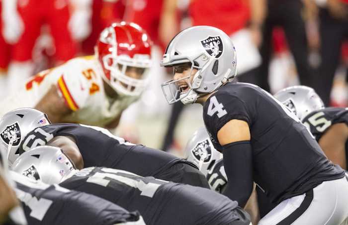 Nov 22, 2020; Paradise, Nevada, USA; Las Vegas Raiders quarterback Derek Carr prepares to take the snap in the fourth quarter against the Kansas City Chiefs at Allegiant Stadium. Mandatory Credit: Mark J. Rebilas-USA TODAY Sports